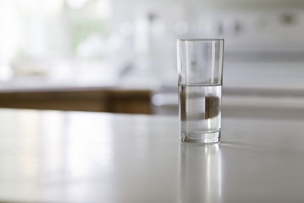 Glass of water with soft light on a wooden table